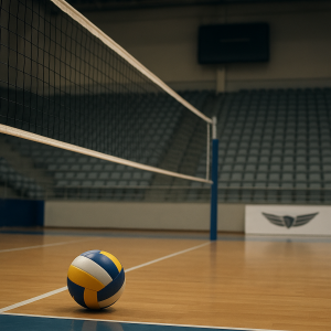 An empty indoor volleyball court with a ball by the net and a blank